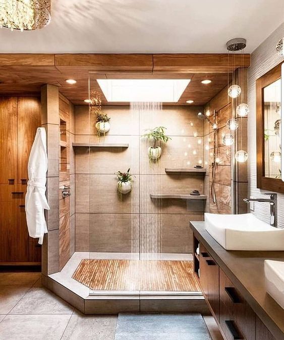 a warm-colored spa-like shower space done in neutrals and with a rain shower and lights for relaxation