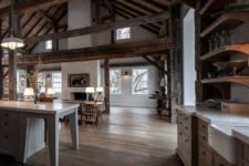 24 a cozy barndominium with multiple beams and much stained wood in decor, a white fireplace