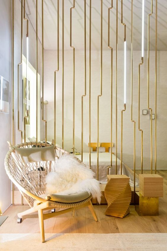 a minimalist room divider of wood and gilded metal plus lights looks really wow