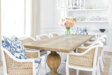 24 a rustic wooden table on large legs and cane chairs make up a traditional beach dining space