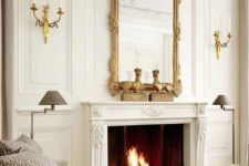 26 a neutral living room with a chic working fireplace that is accented with a vintage frame mirror that adds style