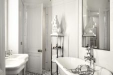 a chic vintage-inspired Parisian bathroom with a tiled floor, a gorgeous whimsy chandelier, a free-standing sink and a statement mirror