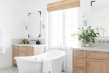 a welcoming transitional bathroom with wooden cabinets and wicker shades plus a basket and a mosaic tile floor