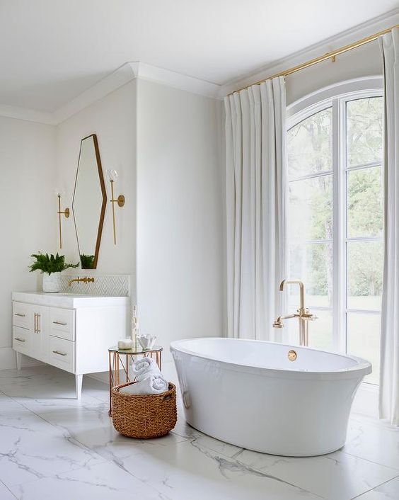 an oval tub, a gorgeous view and a vintage vanity plus a geometric mirror make this transitional space amazing