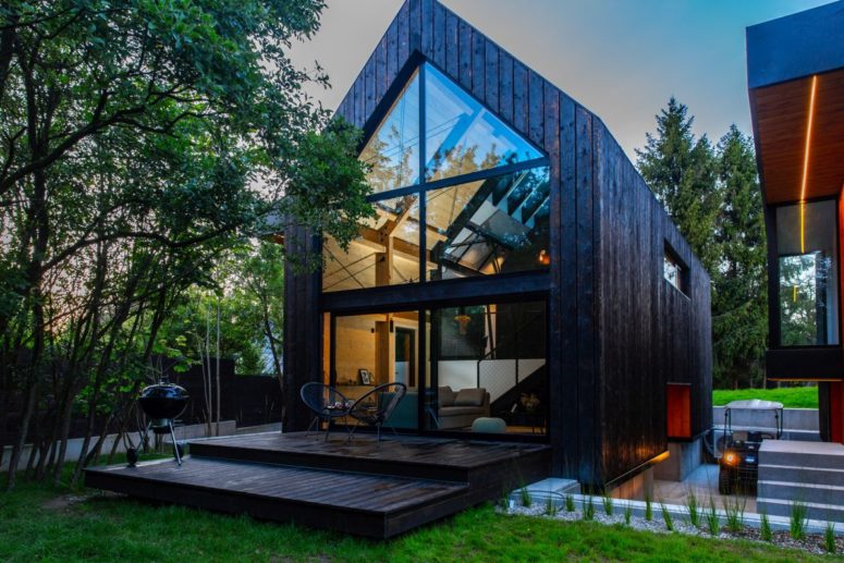 This contemporary cabin is A framed and features dark wood frames that help it better blend in with the natural surroundings