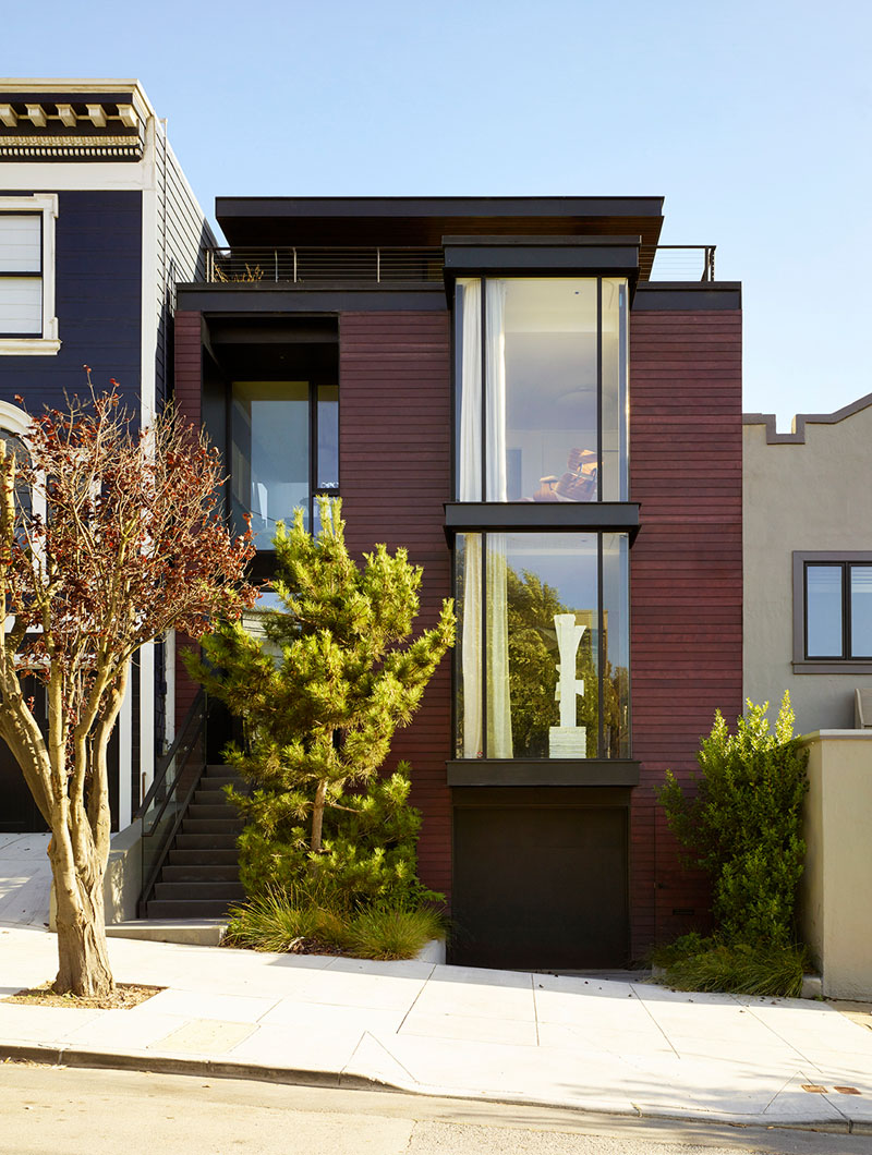 This contemporary home is done with a burgundy facade and features cool contemproary interiors with a character