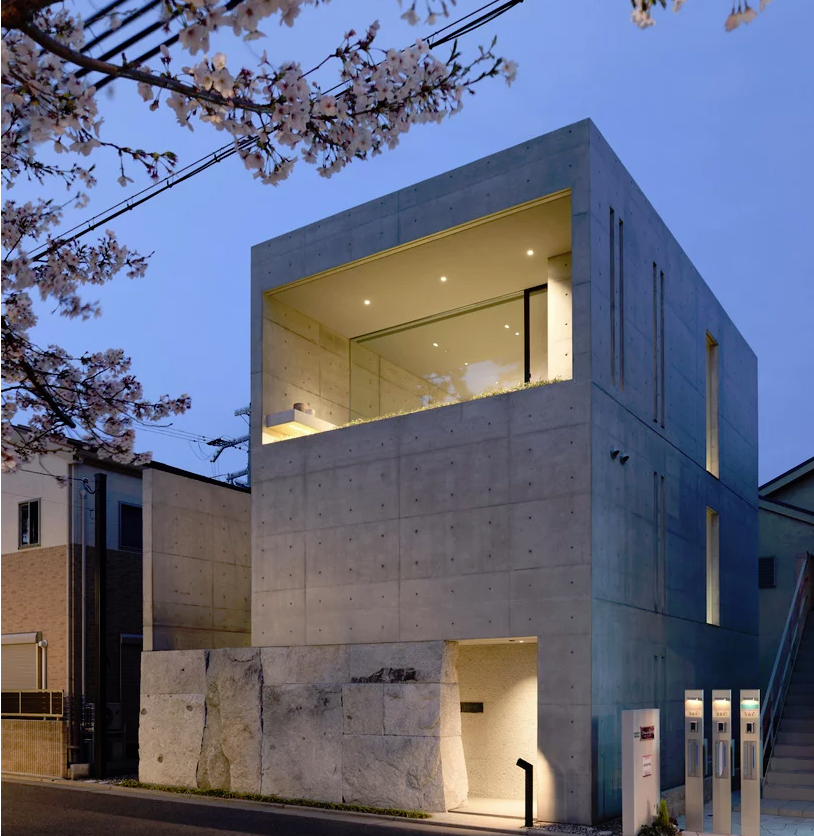 This minimalist home is built of concrete atop a natural stone base and is located in one of the best regions to enjoy cherry blossom in Japan