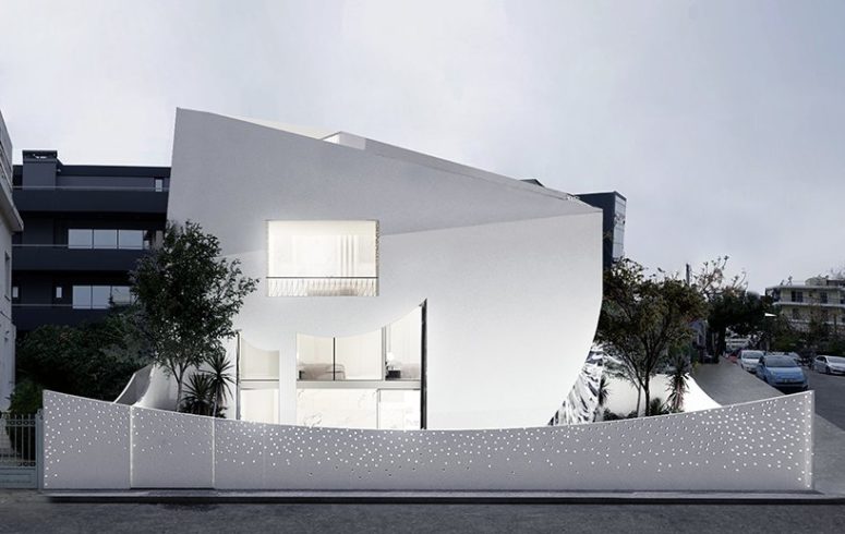 This unique minimalist house in white is filled with light and has a perforated facade, its interior and exterior are both unusual