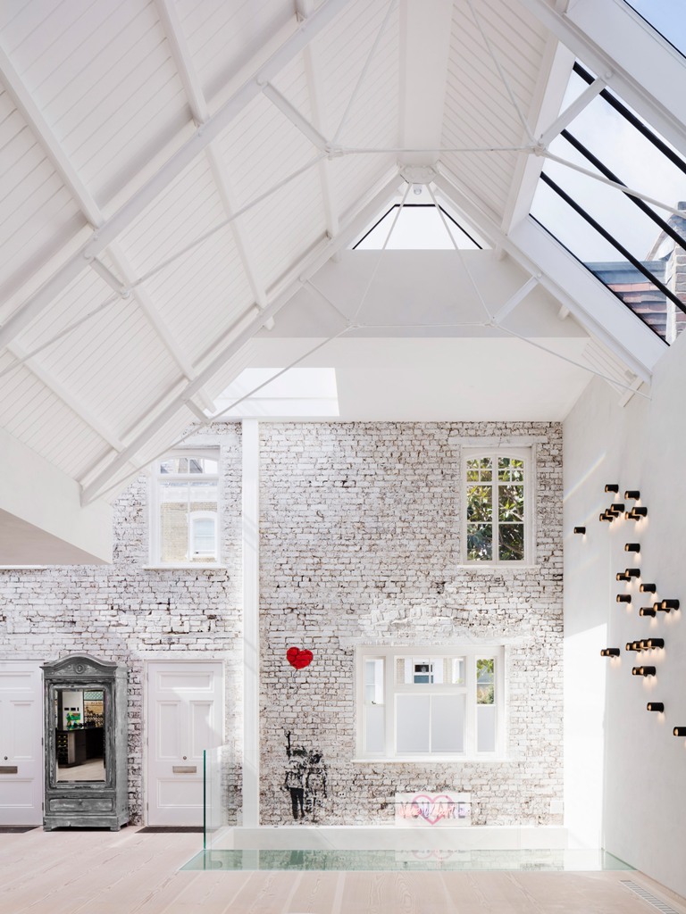 The architects took best of sloped ceilings making skylights, highlighted the brick walls and added art everywhere