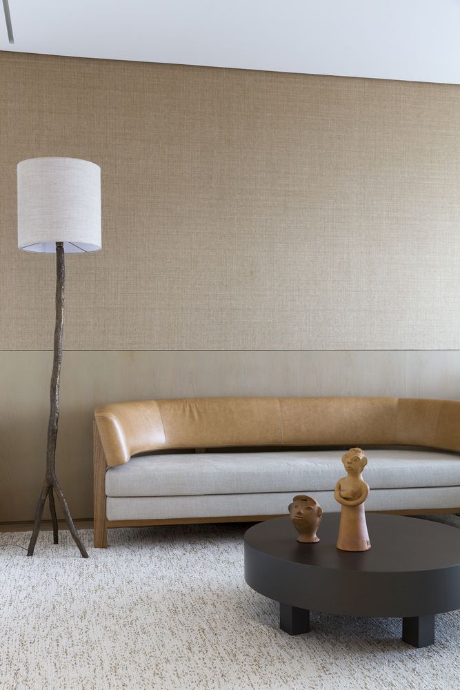 The furniture is contemporary and very elegant, with much texture and unique details like a branch lamp base