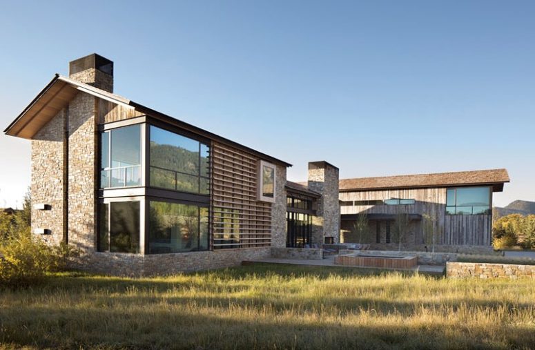 The house may resemble a modern barn of wood and stone, with glazed walls and terraces