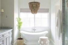 02 a gorgeous glam bathroom chandelier that differs in color and makes a statement in the space with its wow look