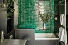 02 a moody bathroom with a statement emerald tile wall, a checked floor and a marble countertop looks super bold