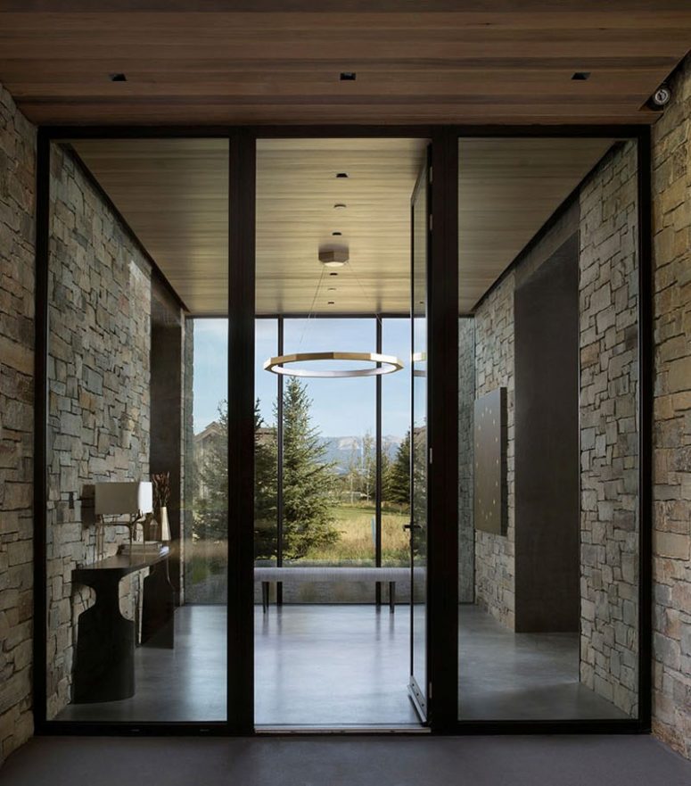 The entrance takes a full advantage of the location - its glazed wall gives a chic view