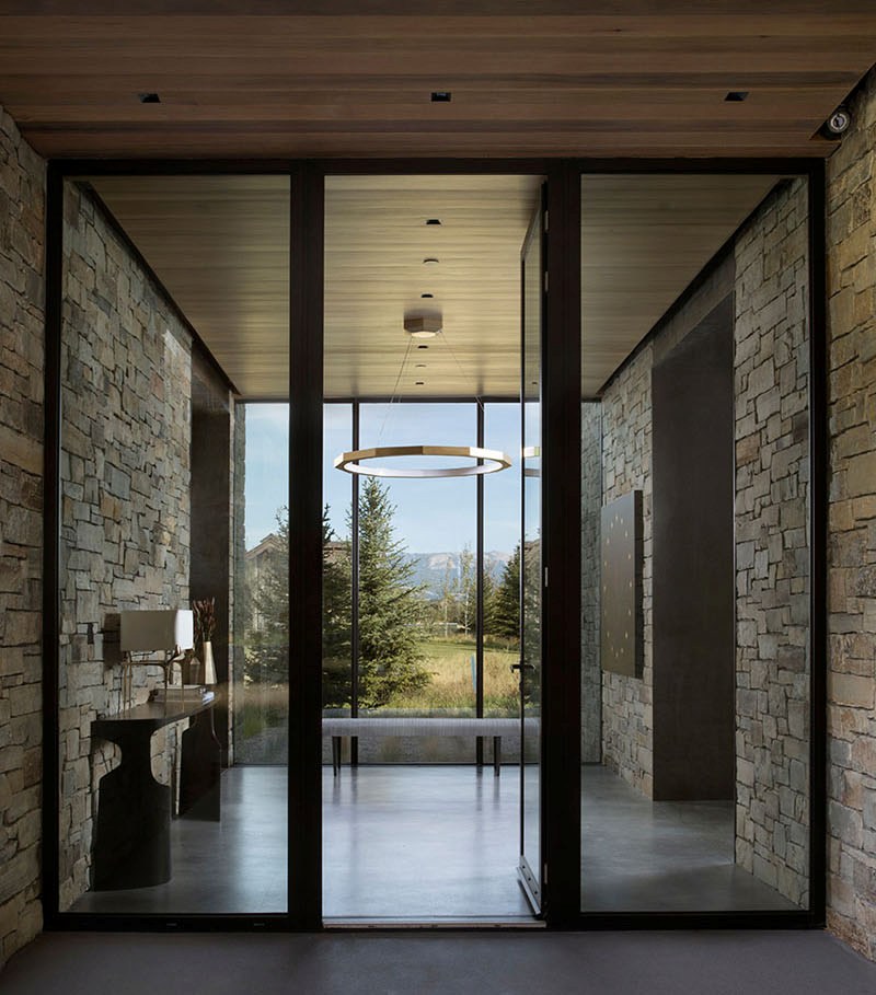 The entrance takes a full advantage of the location   its glazed wall gives a chic view
