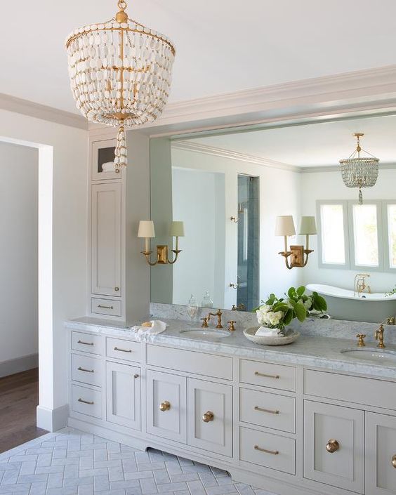 A beautiful brass and mother of pearl chandelier for making a statement in a traditional bathroom