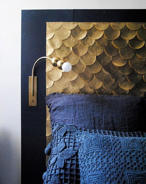 an elegant headboard with a black frame and gold scallops will bring much color and texture to the space