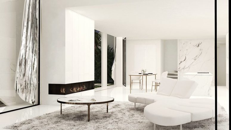The living room is done with white marble, sleek white panels and stylish and simple furniture