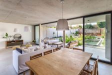 04 The main space is open plan, with a kitchen, dining room and living room, and it’s extended outdoors – to a terrace with a pool