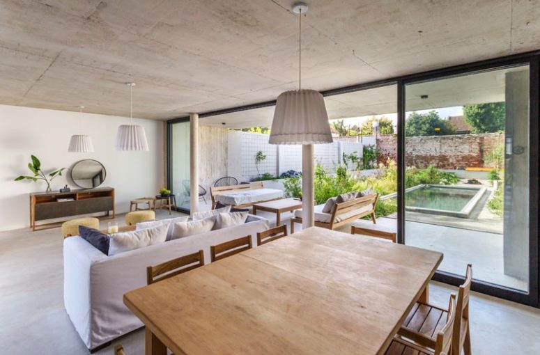 The main space is open plan, with a kitchen, dining room and living room, and it's extended outdoors - to a terrace with a pool