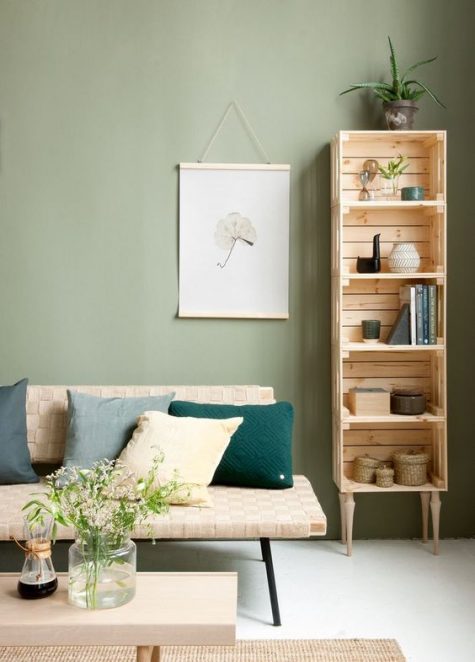 A tall shelving unit of crates and vintage legs naturally fits a mid century modern living room easily