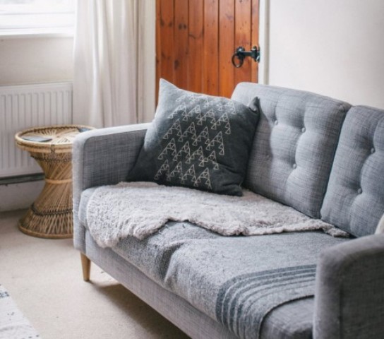 an IKEA Karlstad hack with tufting and mid-century legs is a chic and timeless idea to go for