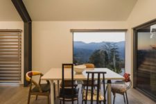 05 A square-shaped dining table with diverse chairs around it creates a very casual and friendly vibe, there’s a gorgeous view