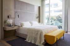 05 The bedroom is done with a floating bed, floating nightstands and a statement yellow bench of leather
