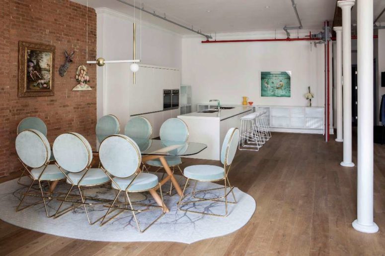 The kitchen is minimalist and is done in white not to distract attention from the bold dining zone