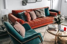 05 a rust-colored velvet sofa with muted and teal pillows plus a teal velvet chair for a bold fall setup