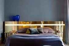 05 a unique and statement-like polished gold headboard is a refined and glam touch to the bedroom decor