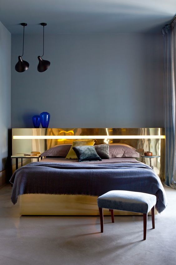 A unique and statement like polished gold headboard is a refined and glam touch to the bedroom decor