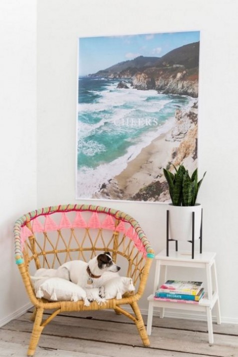 an IKEA Rattan chair hacked with colorful yarn and tassels for a boho feel - ideal for both indoors and outdoors