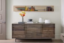 06 Catchy artworks and rustic touches like this credenza make the space more unique