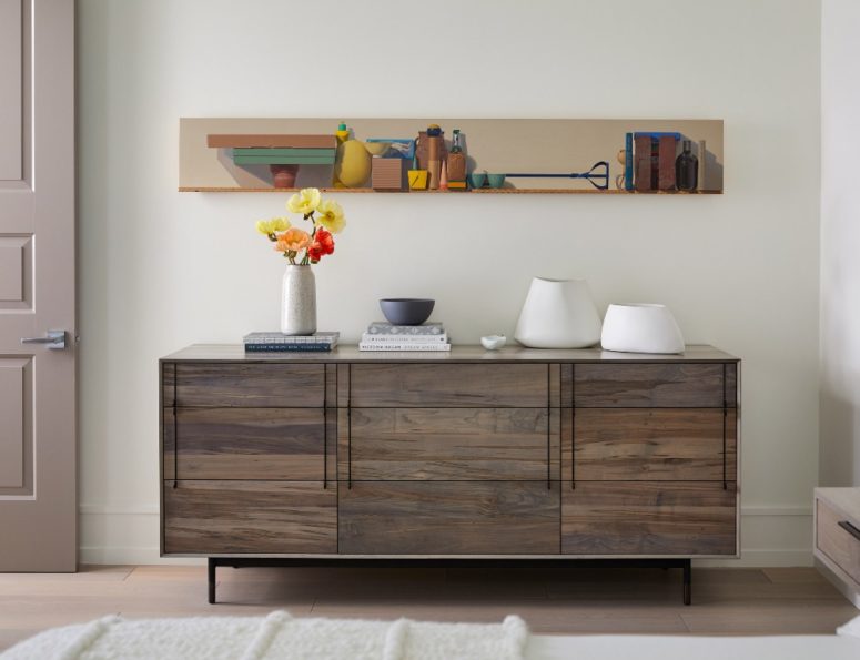 Catchy artworks and rustic touches like this credenza make the space more unique