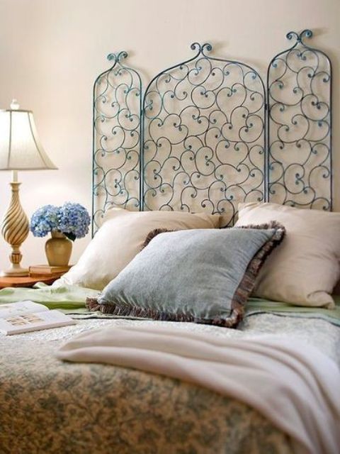 a creative and chic blue forged headboard will add a refined touch to the space