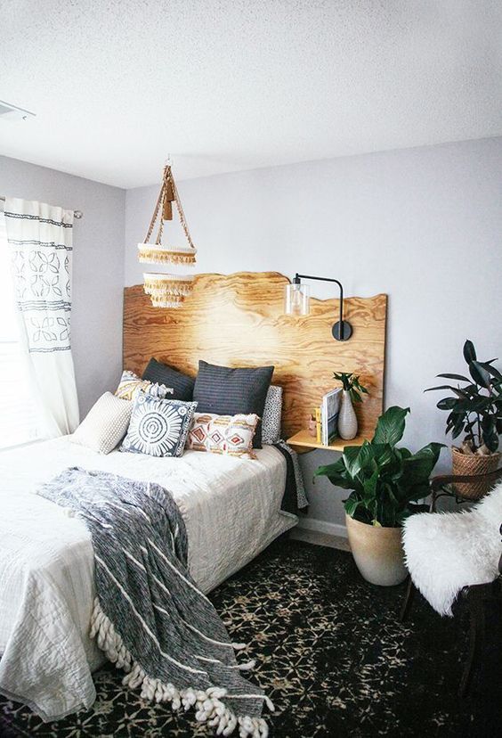 a live edge headboard with floating nightstands and a single lamp attached is a cool idea with a boho feel