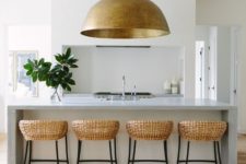 06 an oversized metal pendant lamp echoes with the rattan chairs and brings texture