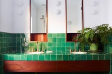 06 green tiles all over the bathroom contrast the rich stain of the wood and copper touches