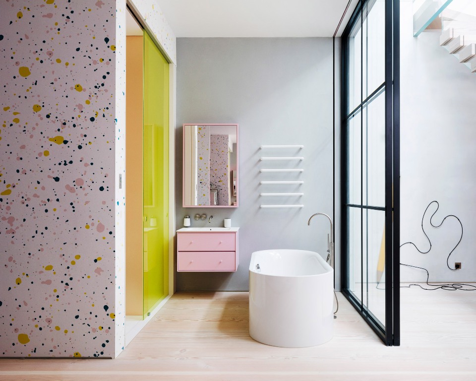 There's another bathroom done with terrazzo, pink and neon yellow touches for a bright look