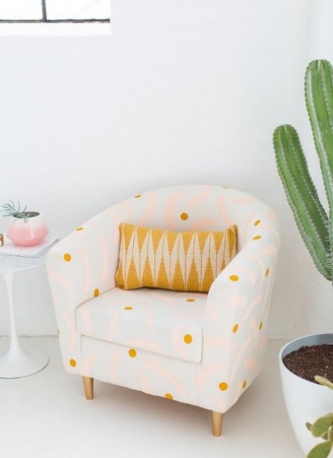 an IKEA Tullsta chair renovation with polka dot printed fabric and a bright pillow will add a cute feel to the space