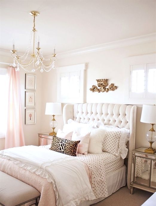 a cute and glam girlish bedroom is completed with a creamy wingback headboard, which is tufted for a more chic look