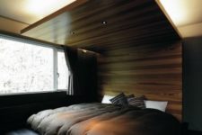 08 a gorgeous wooden headboard extended up to the ceiling features lights and creates a cozy sleeping alcove