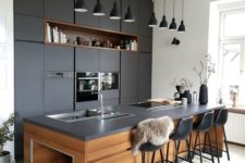 08 a super chic dark kitchen with matching blakc pendant lamps hanging in a row is a cool and bold idea