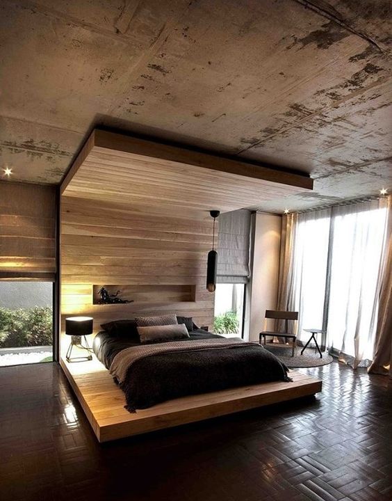 A platform bed extended to the wall and ceiling with a niche and a pendant lamp is an ultra modern idea