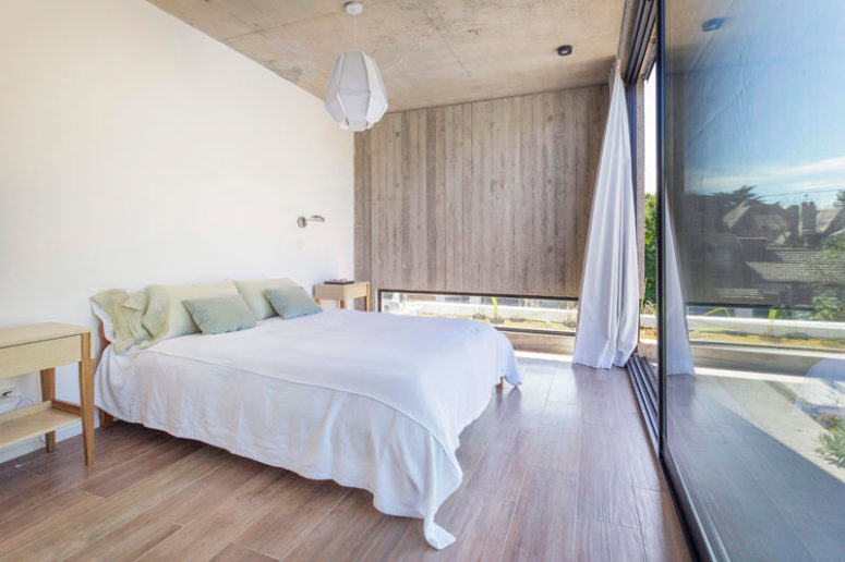 The bedroom is done with a glazed wall, a wooden wall with a small low skylight to make it more private