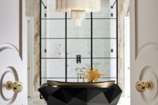 10 a jaw-dropping bathtub with a faceted design and a statement chandelier over it for a bold combo
