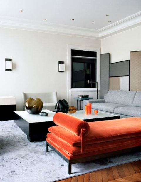 a minimalist interior with a colorful statement - an orange velvet daybed