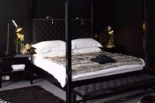 11 a luxurious bedroom with black walls, a crystal chnadelier, animal prints and some lights over the bed