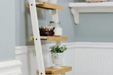 11 a space-saving ladder storage unit made of Ikea towel holders and some wood on them